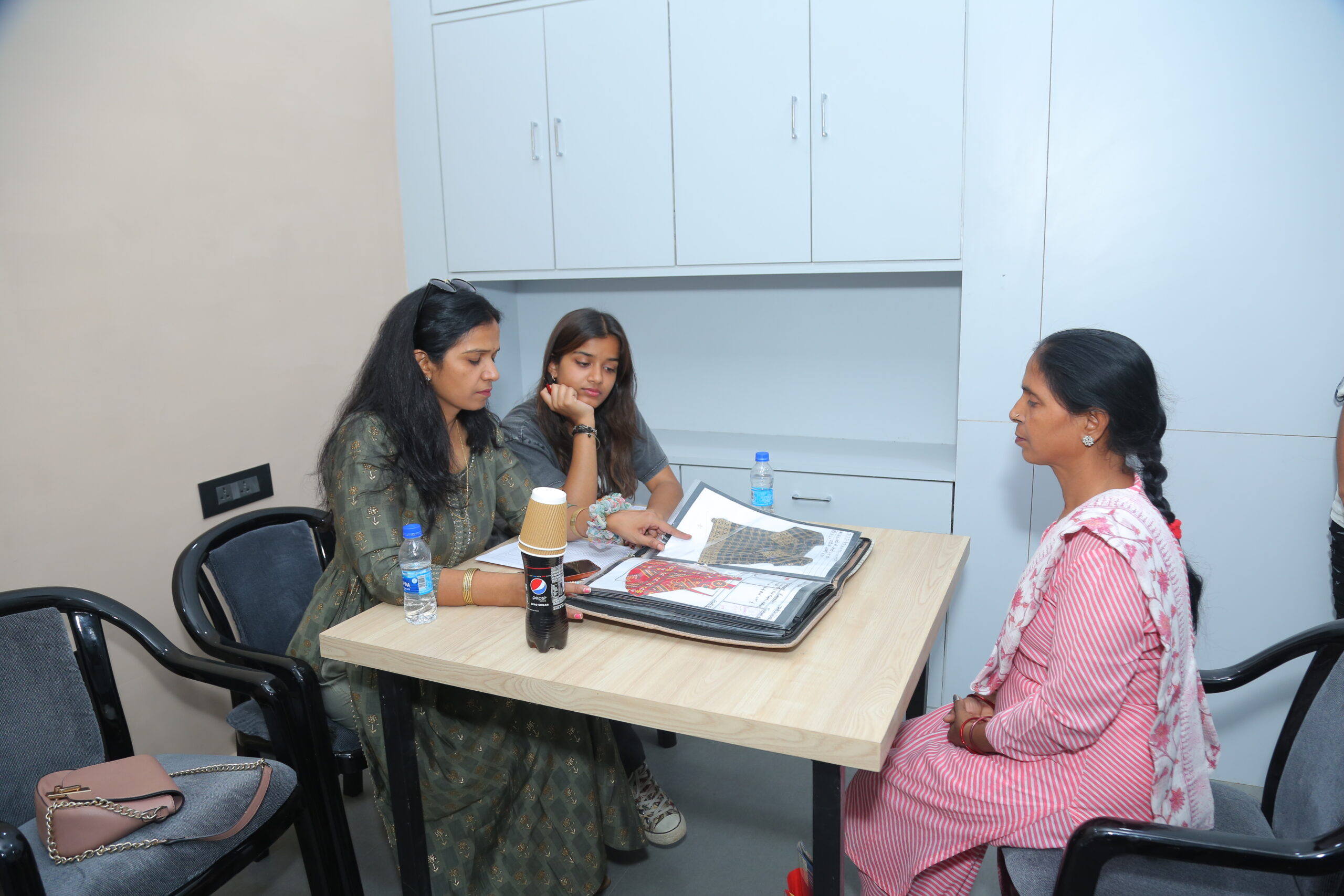 Women participating in campus job fair at SDTT Vocational Institute, engaging with recruiters after completing vocational courses
